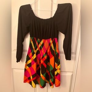 70s style groovie vintage dress. black top with bright retro pattern bottom